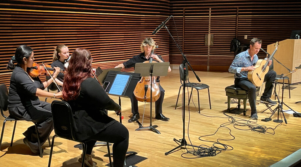 Guitar and string quartet on stage